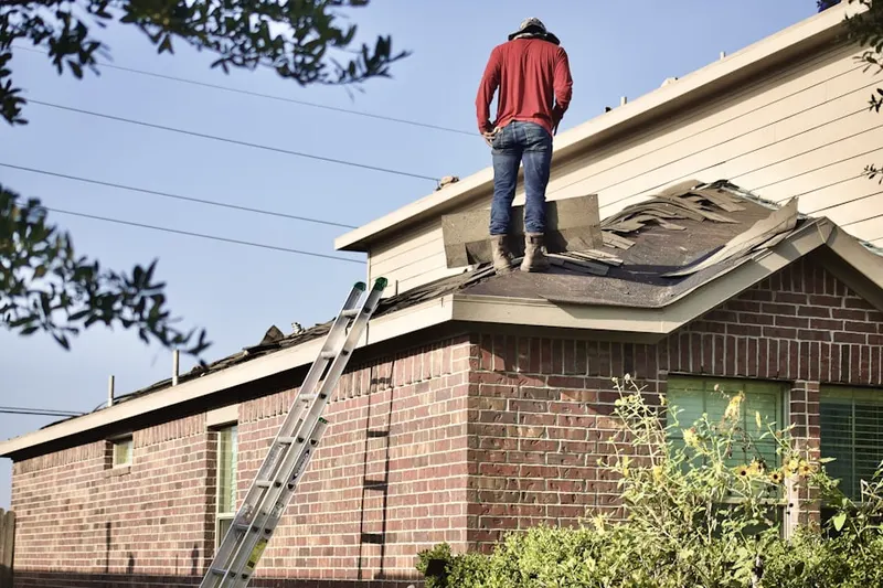 Professional roofer working on a residential roof in Lower Merion